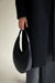 Structured curved shoulder bag in black — main image