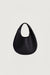 Curved leather hand bag in black — main image