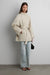 Belted funnel neck jacket in beige — main image