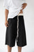 Knee-length trousers in black — main image