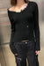 Distressed v-neck sweater in black — main image