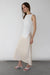 Fitted sleeveless top with asymmetrical hem in cream — main image
