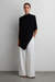 Asymmetrical drape cape top in black — main image